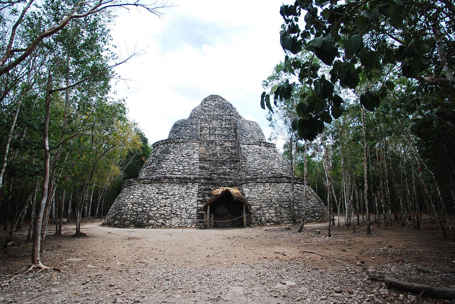 La pirámide cónica y redondeada de Xaibé en Cobá, en un claro de la selva en un día nublado.