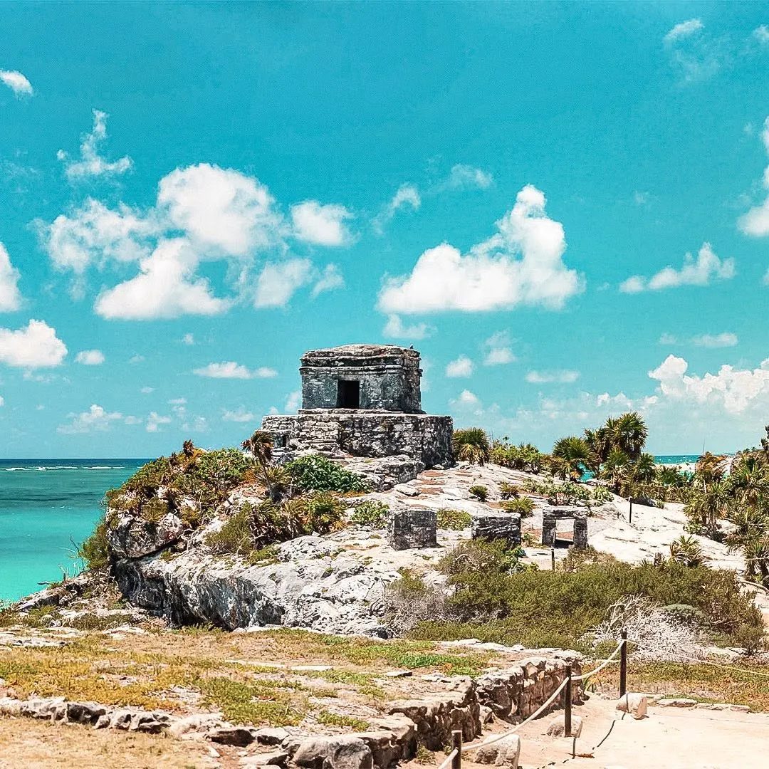 A Mayan ruin on the clifftop with the Caribbean behind it