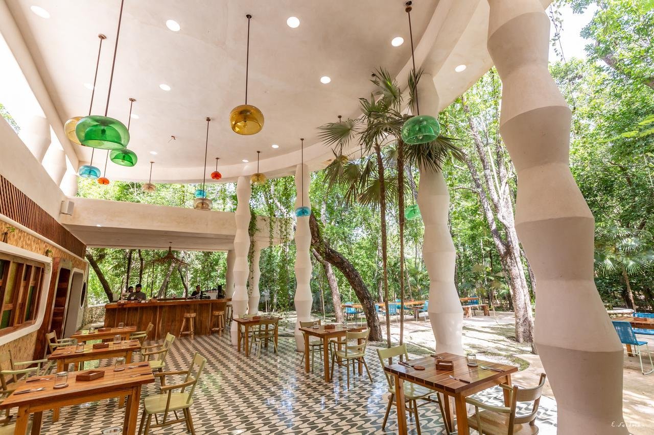 The open dining room of Tierra among the trees at Holistika, Tulum