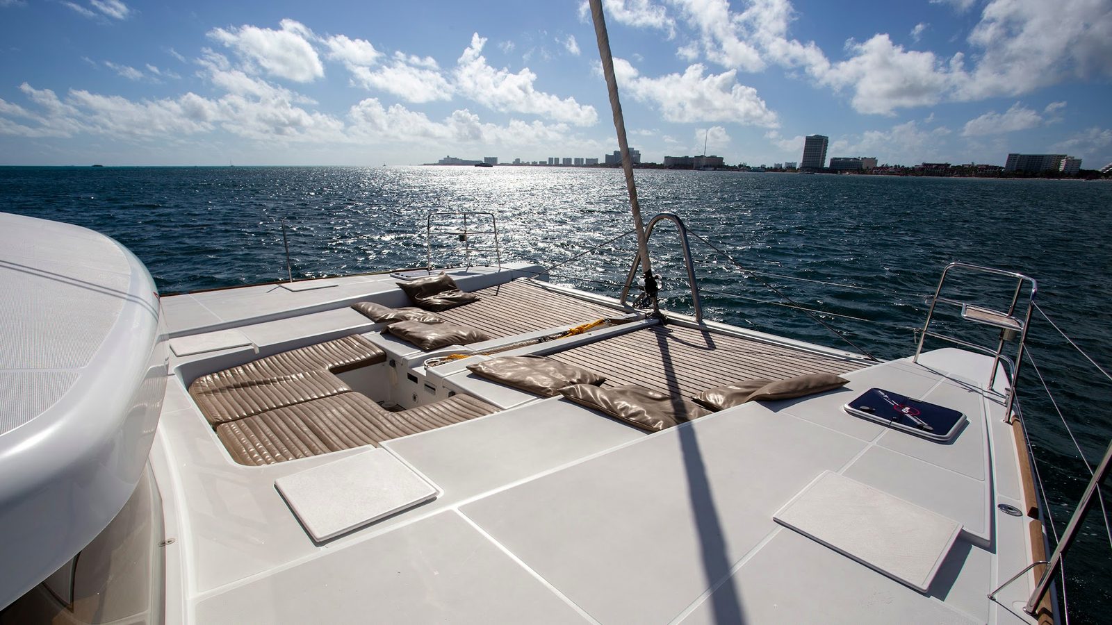 Sun pads on the bow deck, the Hotel Zone on the horizon