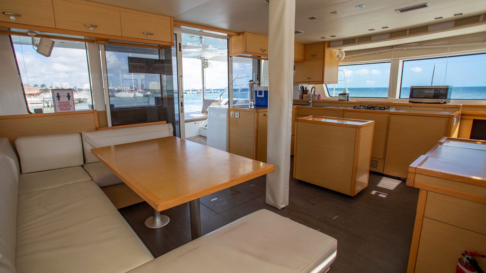 The indoor salon with its dining table and galley