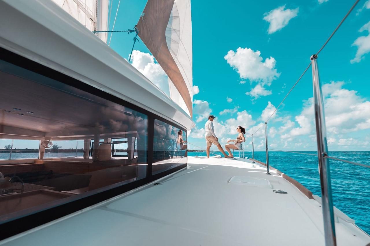 The side deck under sail, with guests at the bow