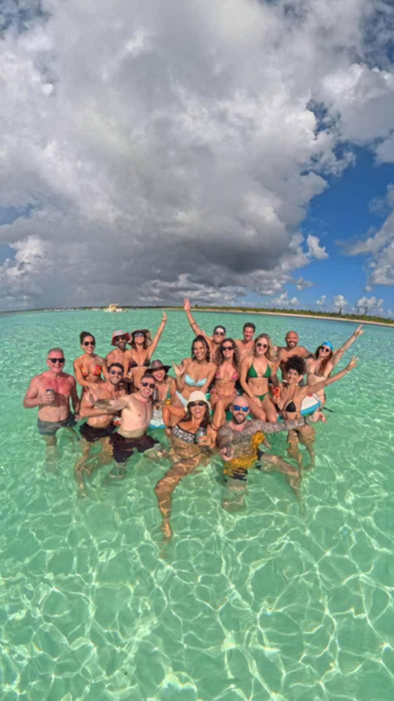 Guests standing in the shallow, clear water of El Cielo