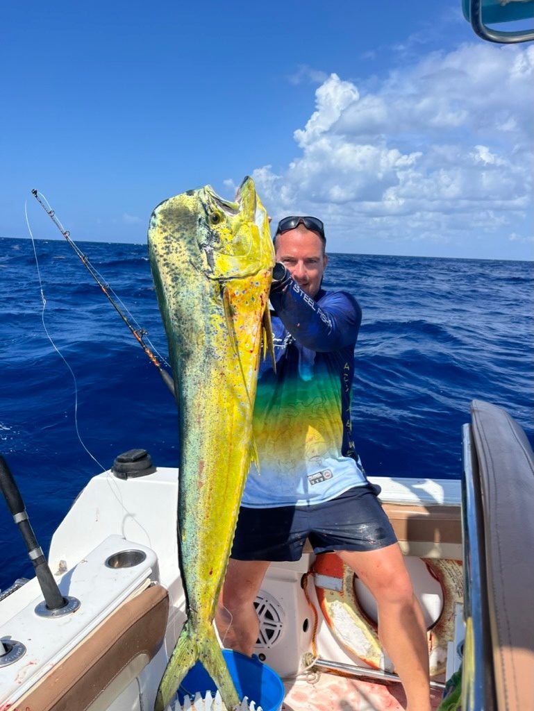 An angler holding a mahi-mahi