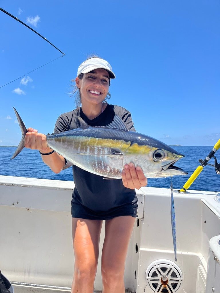 An angler smiling with a tuna
