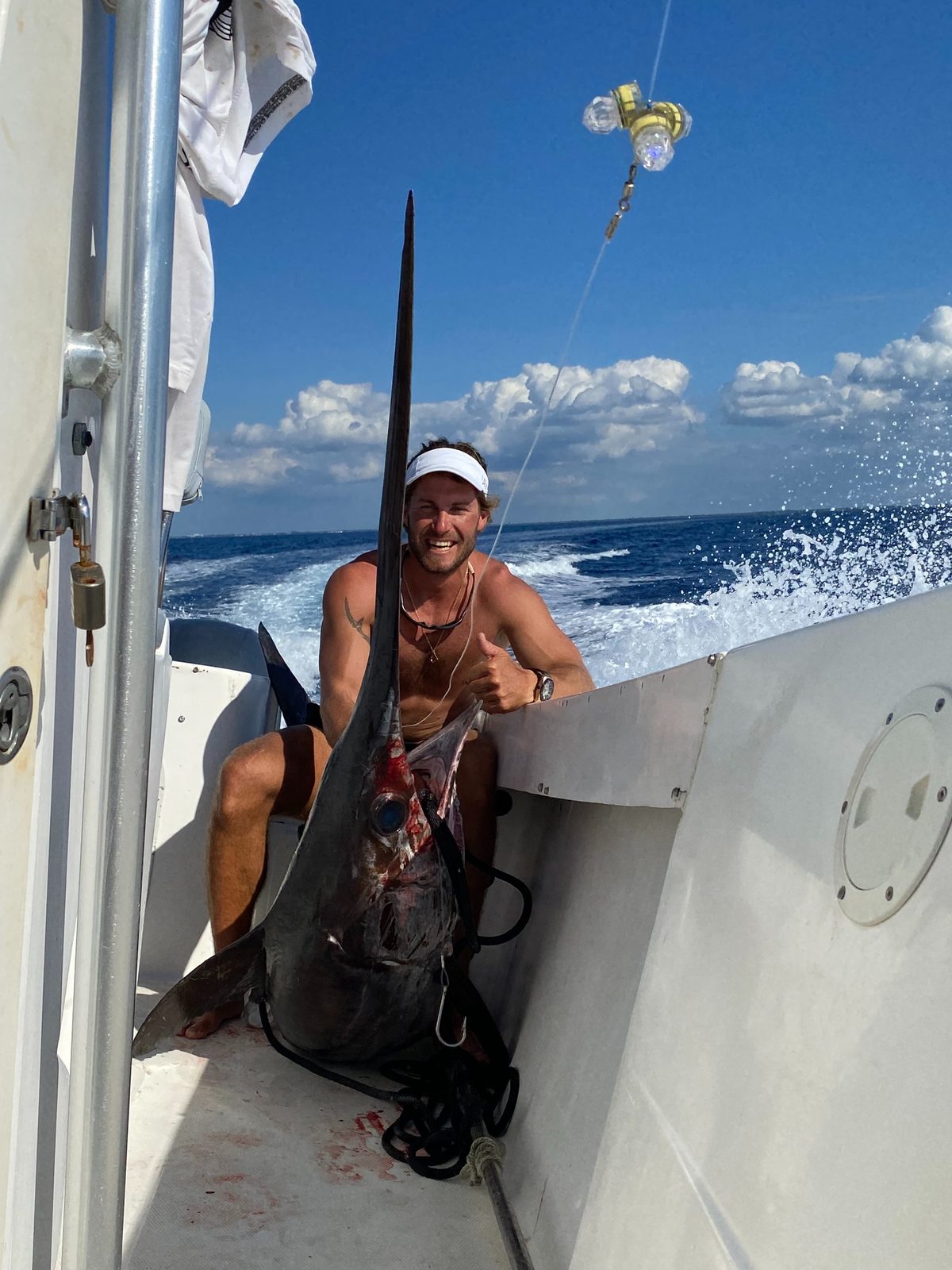 A swordfish on deck with the boat underway
