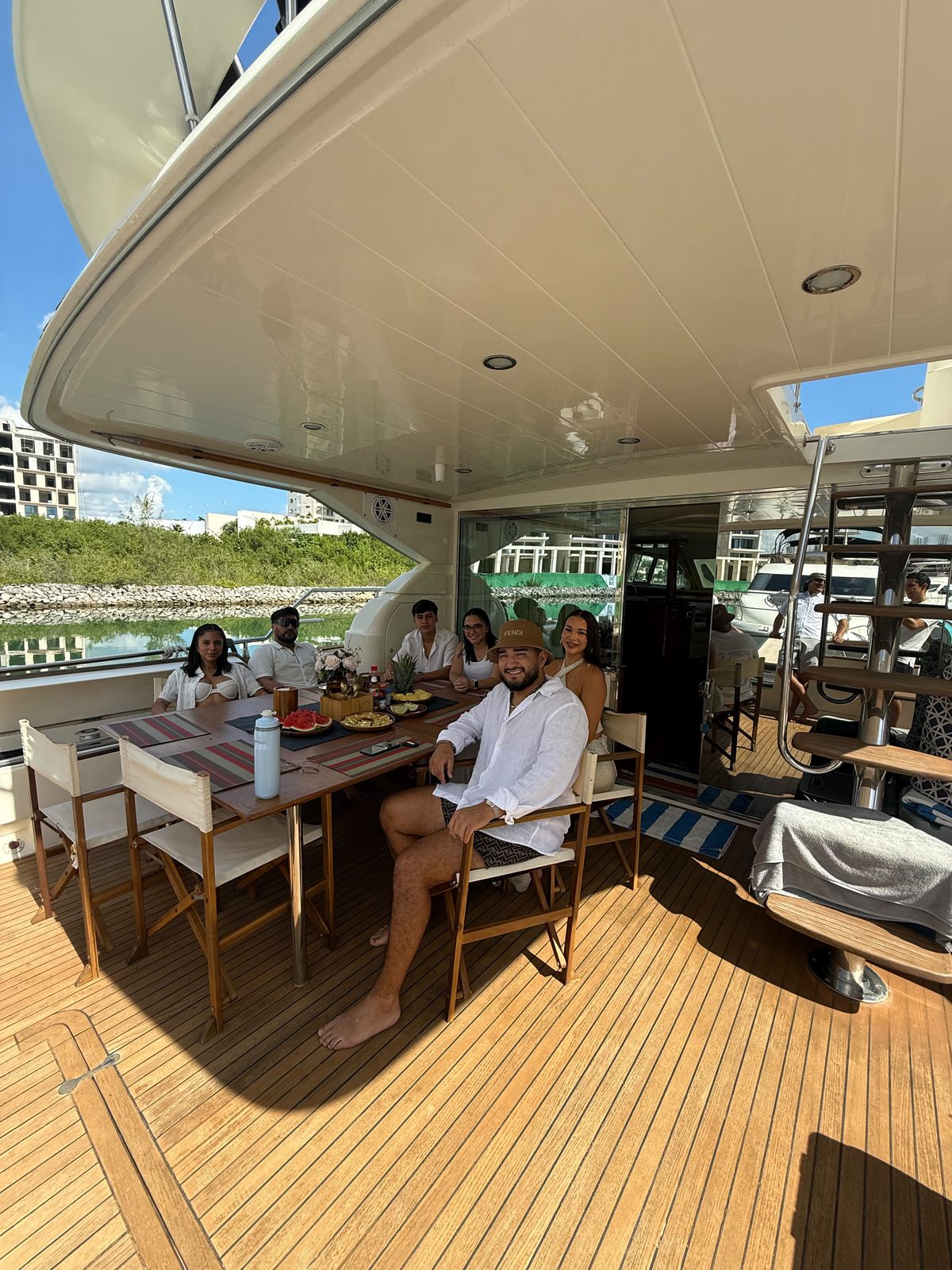 A group around the aft deck table, with fruit on board