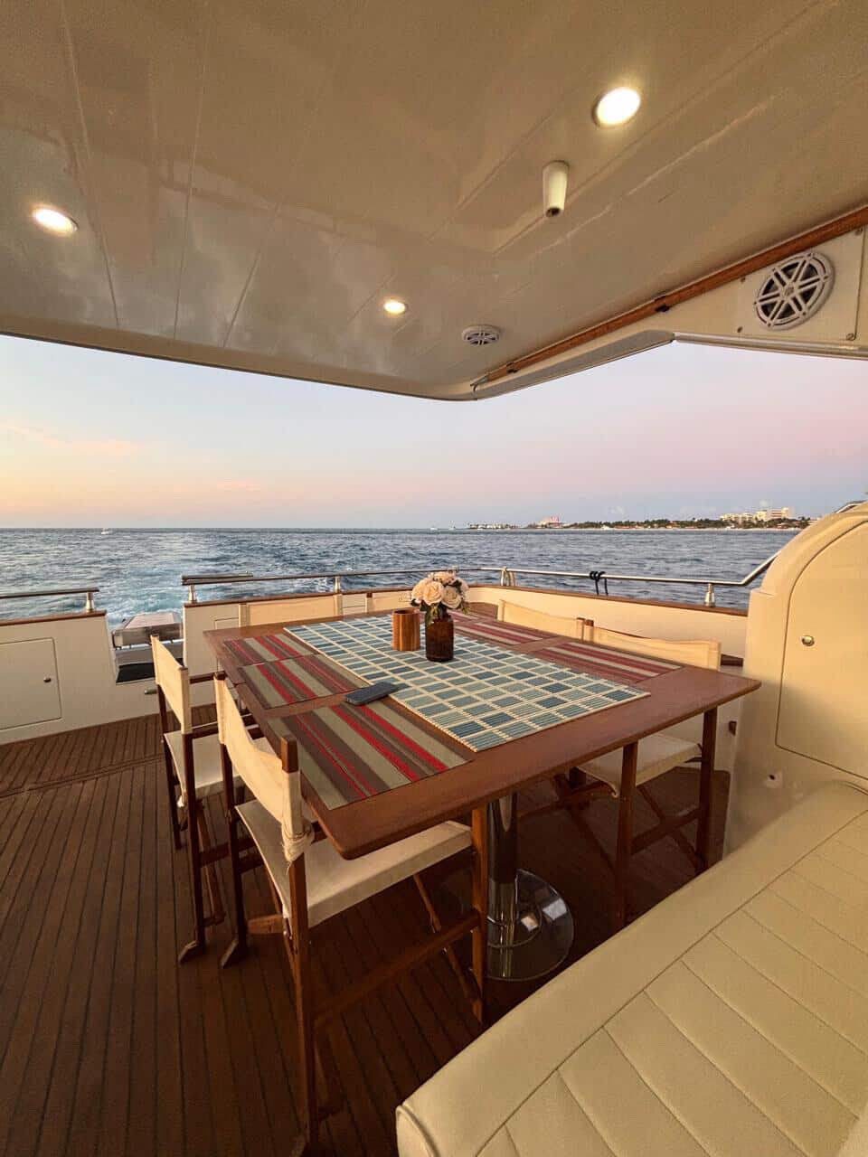 The aft deck table, in the shade, set for the group at sunset