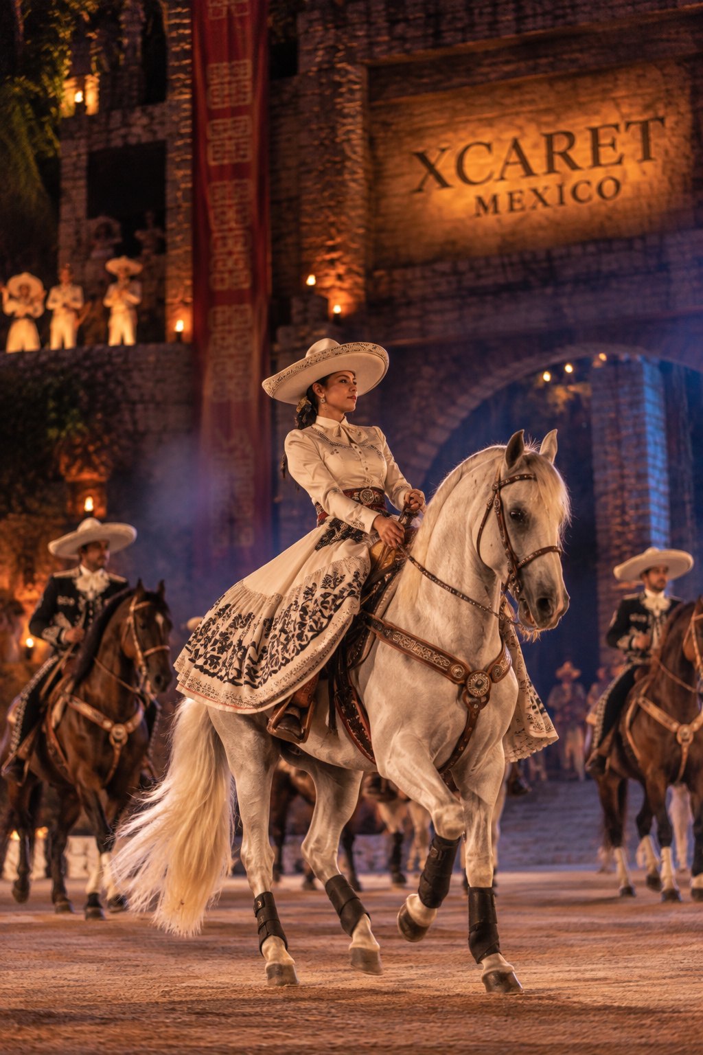 Charros riding across the stage