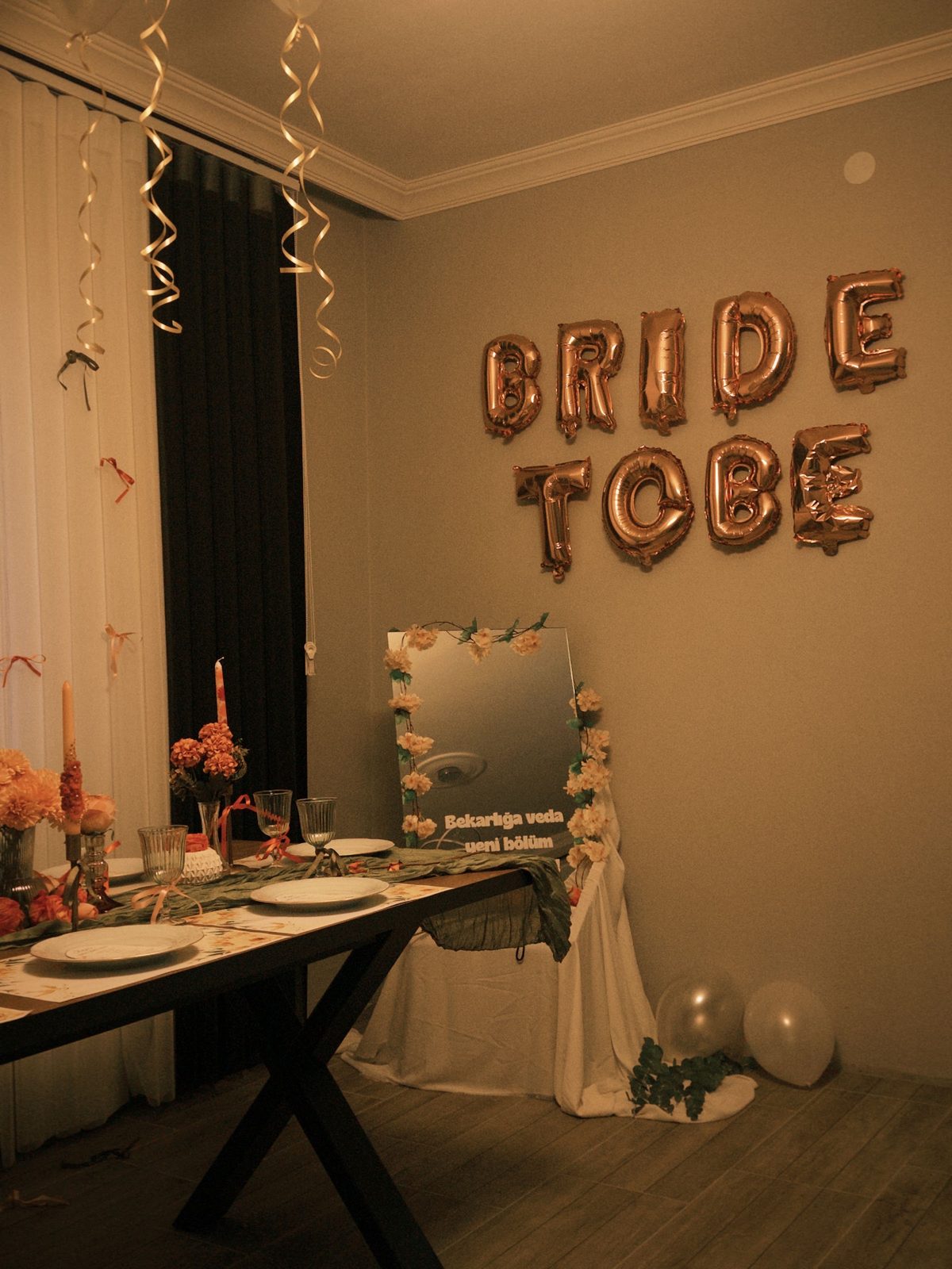 A room dressed for a celebration with balloons and a set table