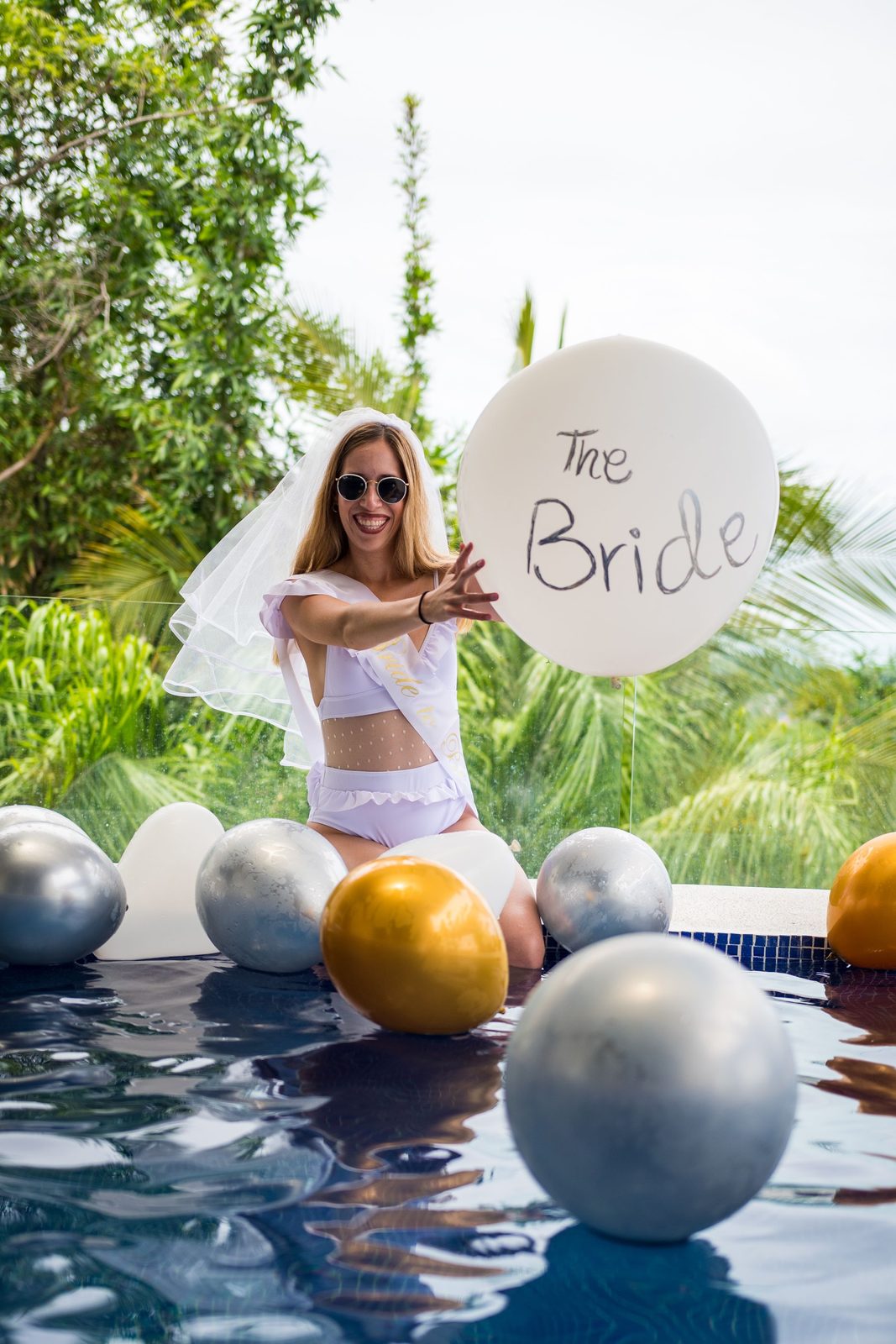A bride in the pool among balloons