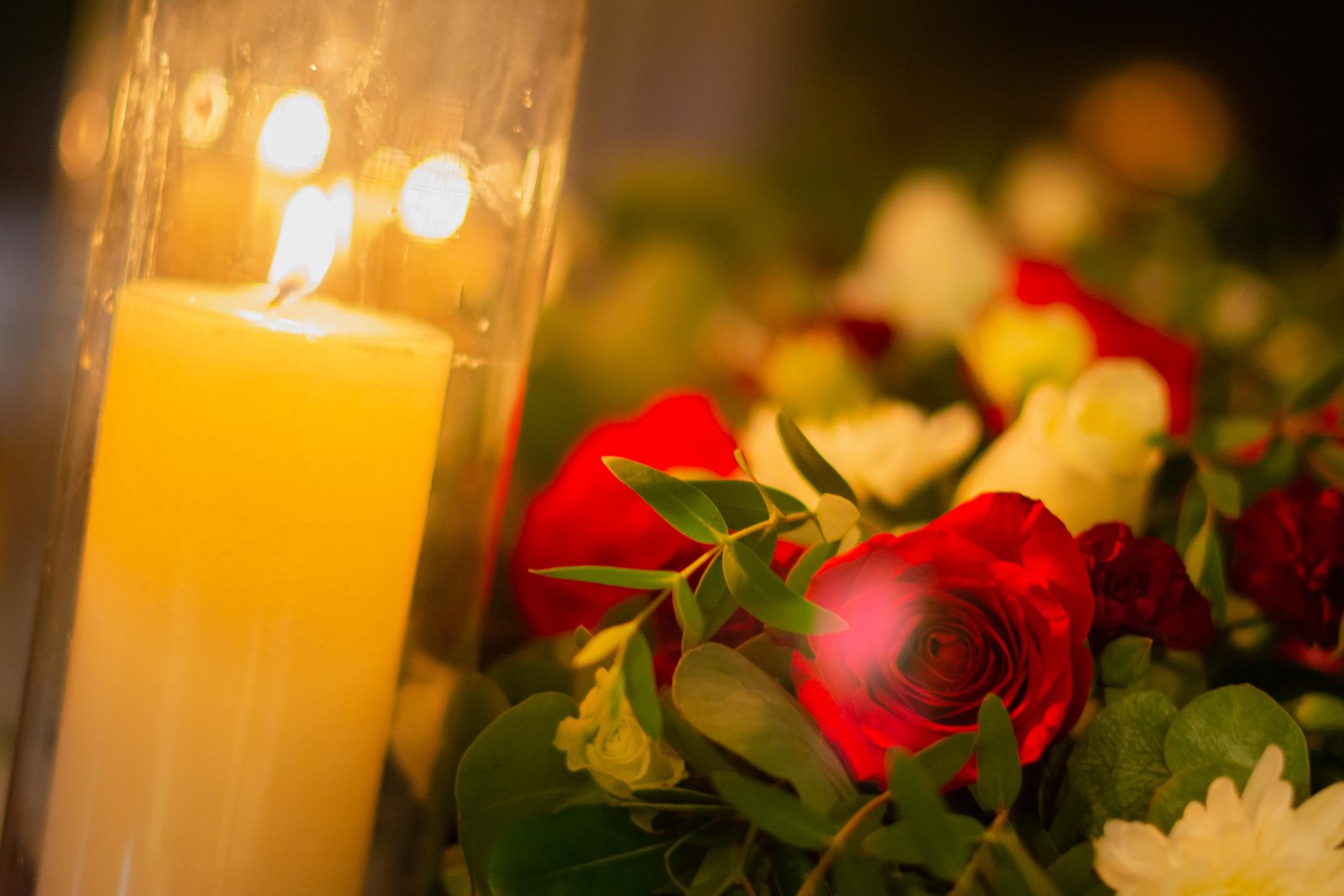 Red roses and candlelight on a set table
