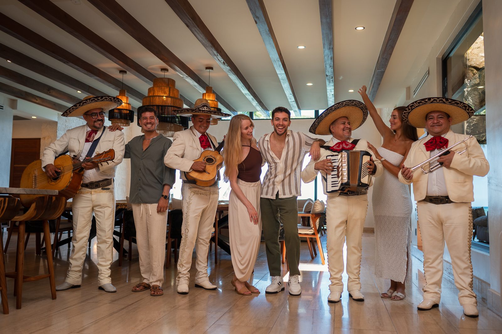 Guests standing with the mariachi band inside the villa