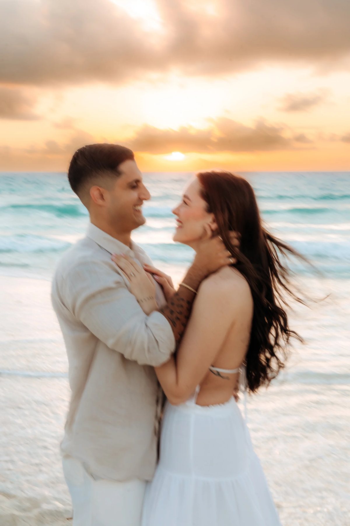 A couple embracing on the beach at sunrise
