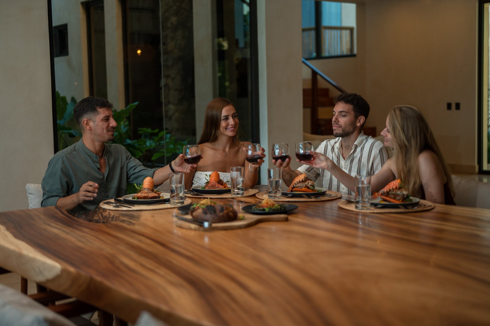 Guests toast over dinner at the villa table