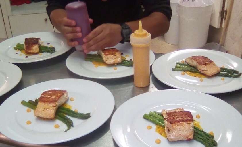 Plating salmon with asparagus for the whole table