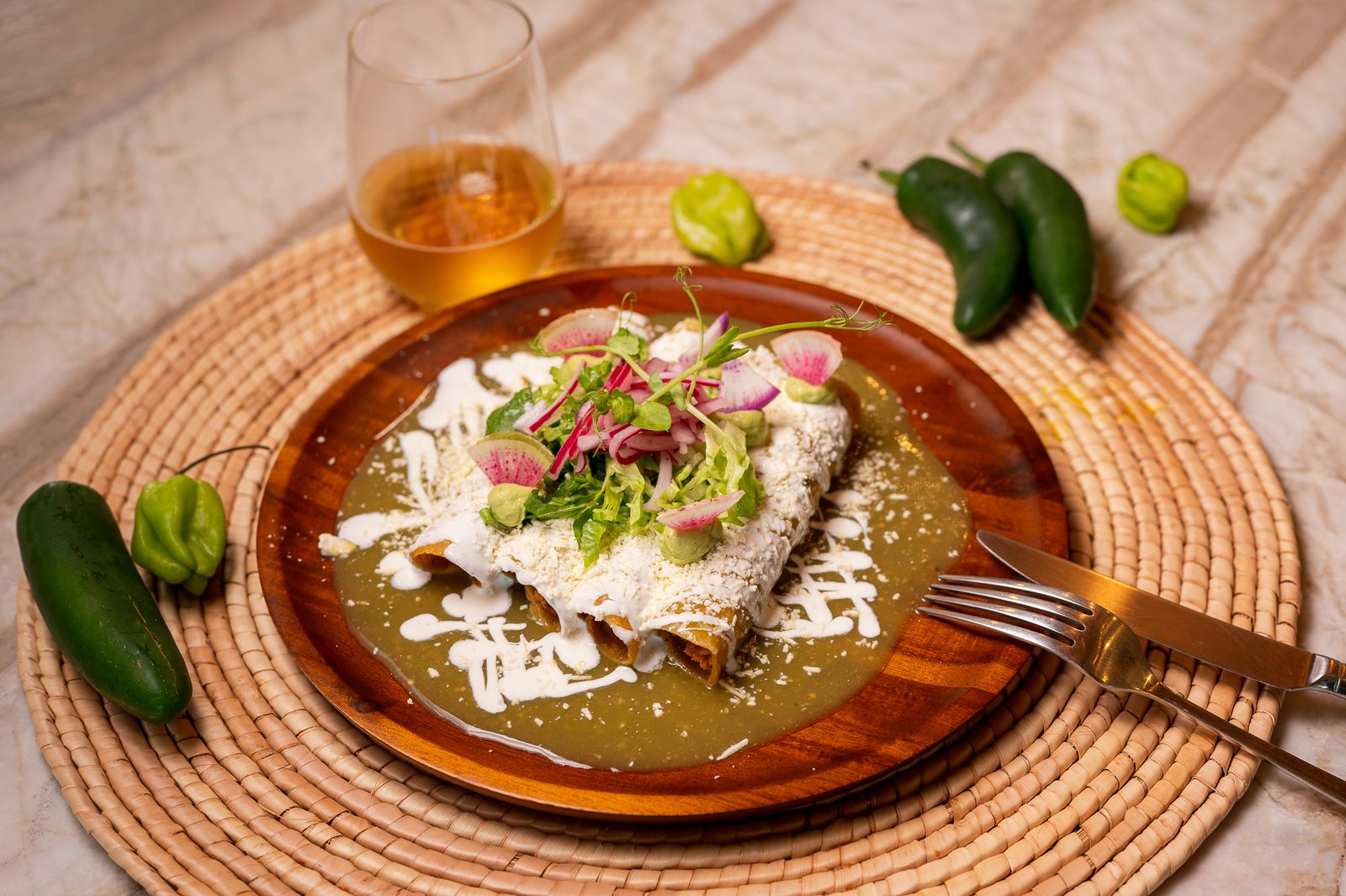 Enchiladas with green sauce, cream and fresh herbs