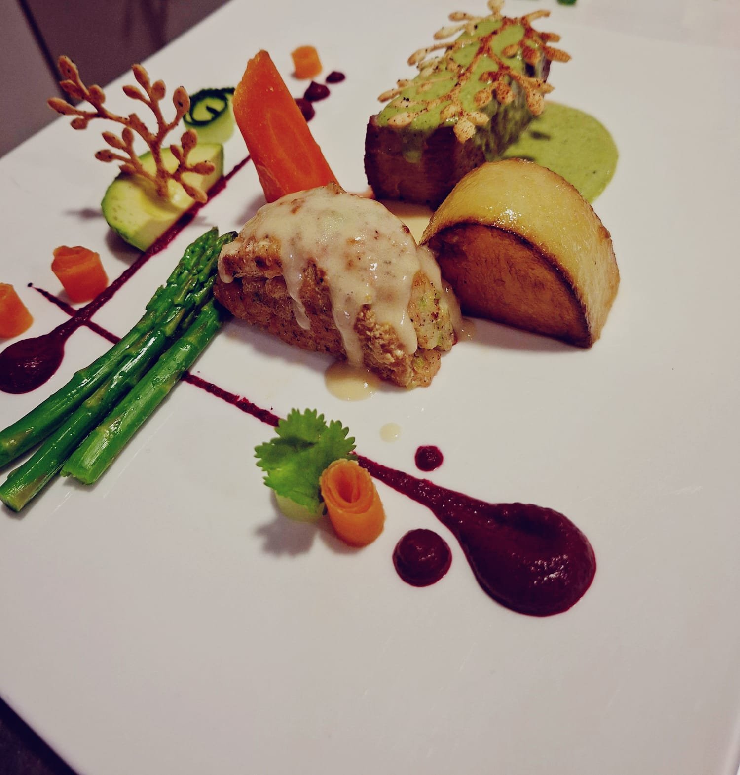 A plated main course with asparagus and vegetables