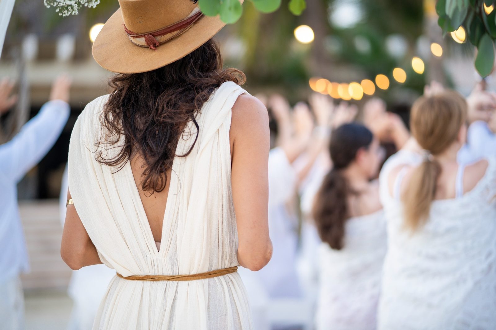 Guests dressed in white gathered for a ceremony by the sea