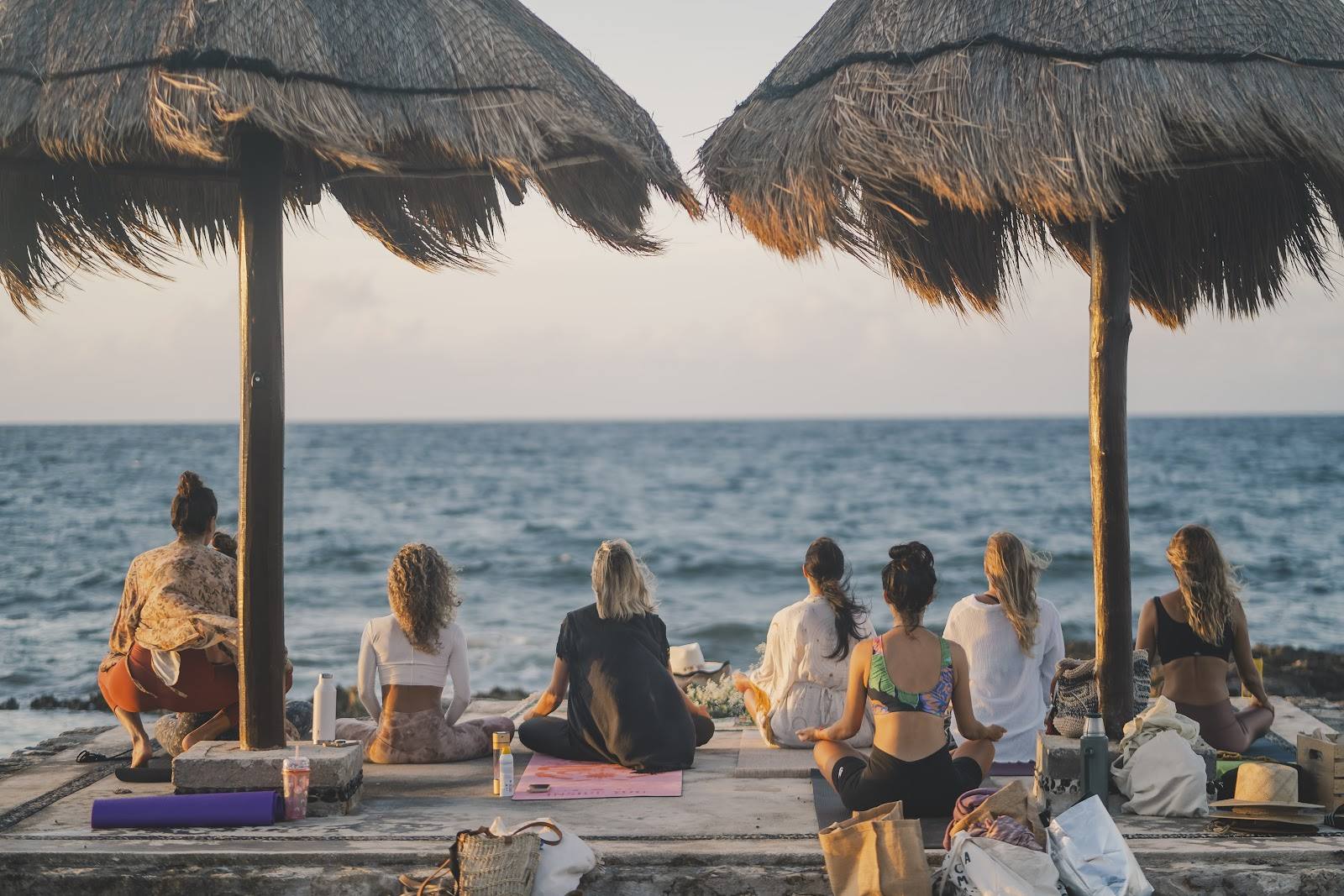 A group meditation facing the sea