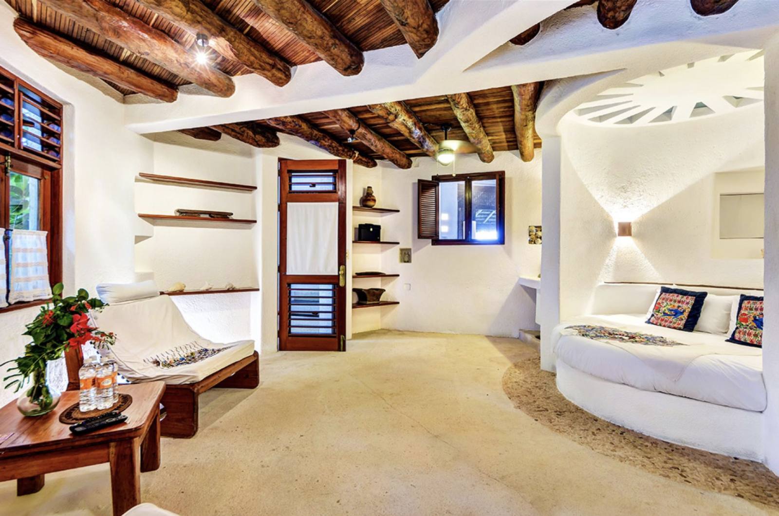 A suite with a round bed built into the wall