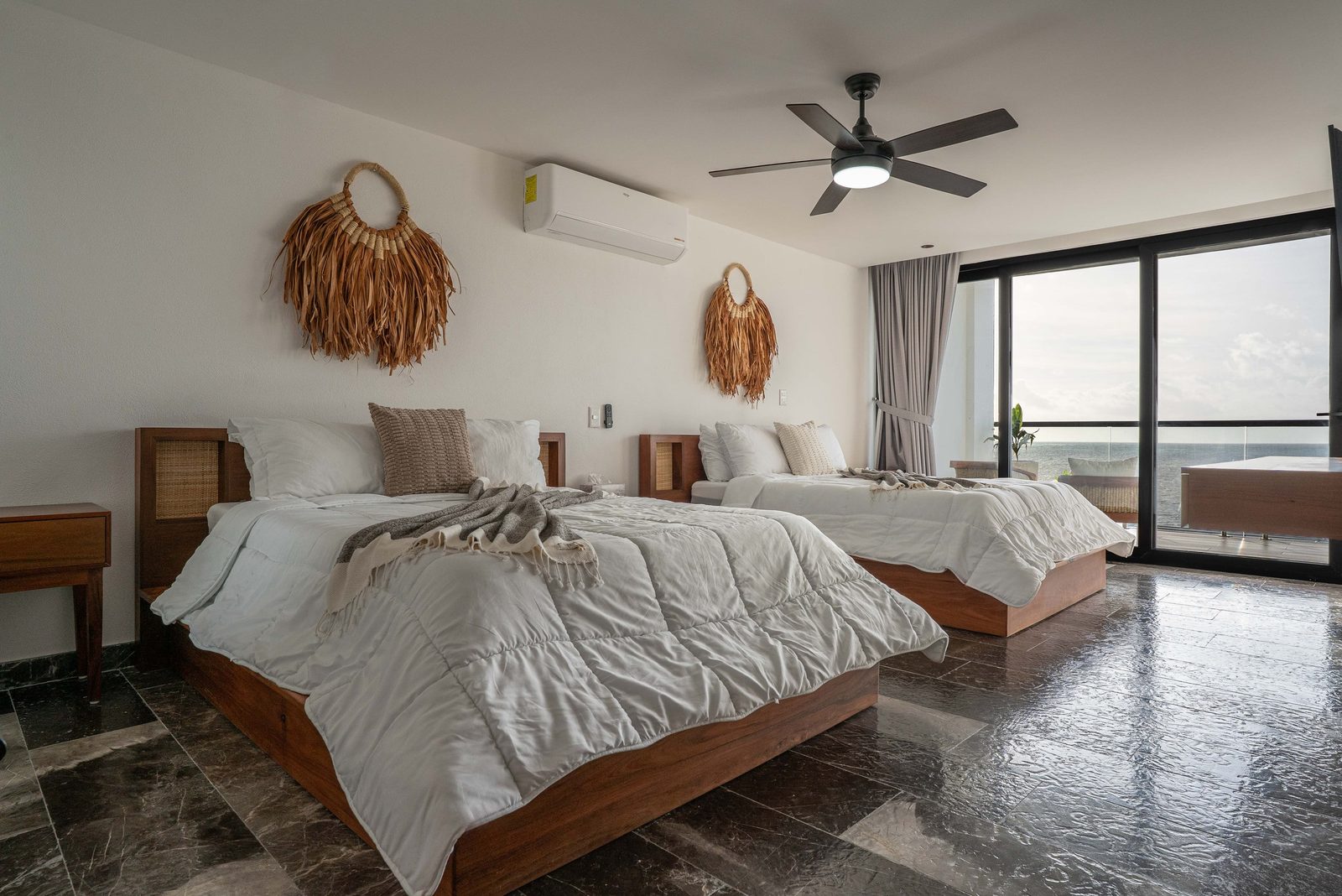 Bedroom with two beds and a sea view