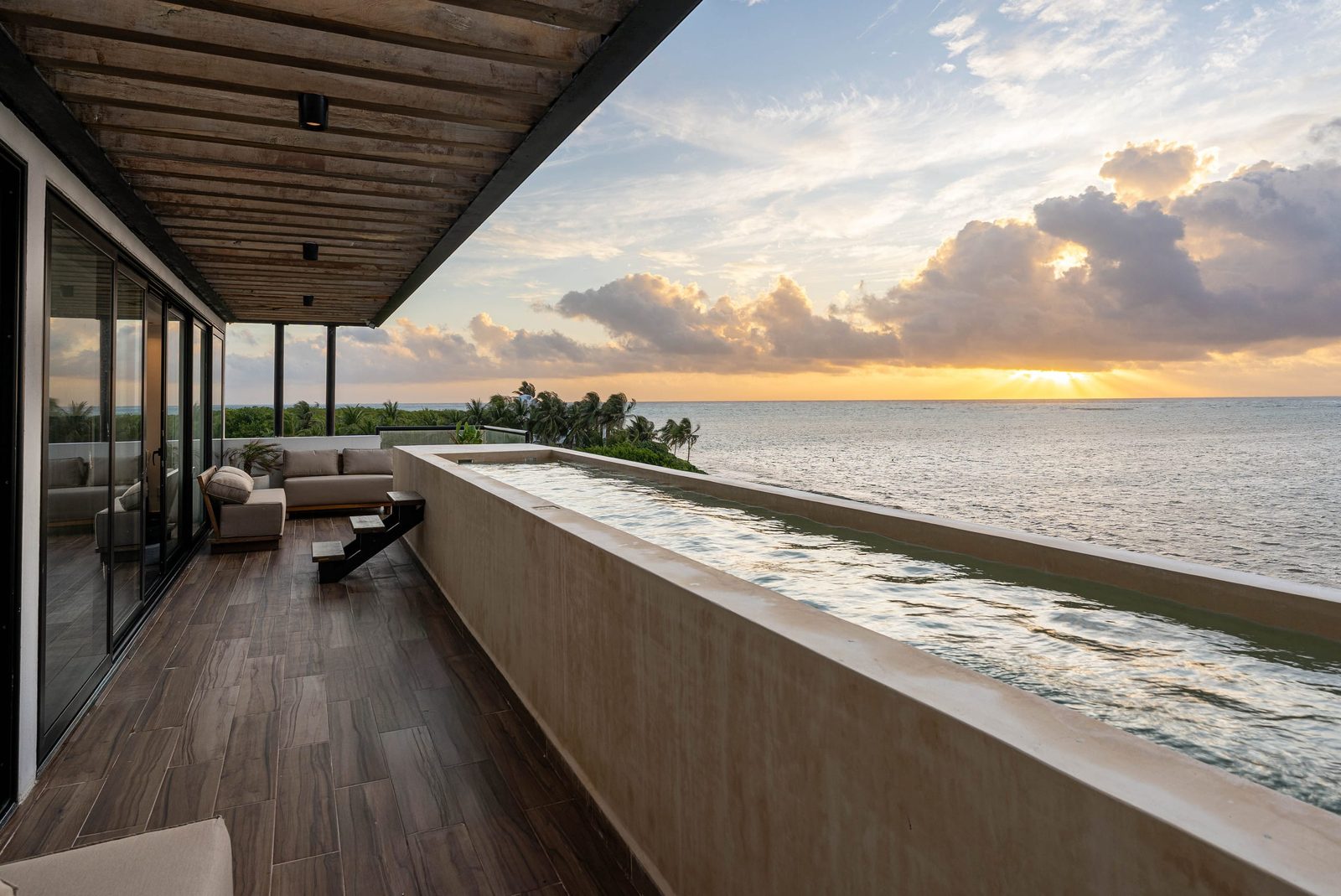 The upper-level pool along the terrace at sunset