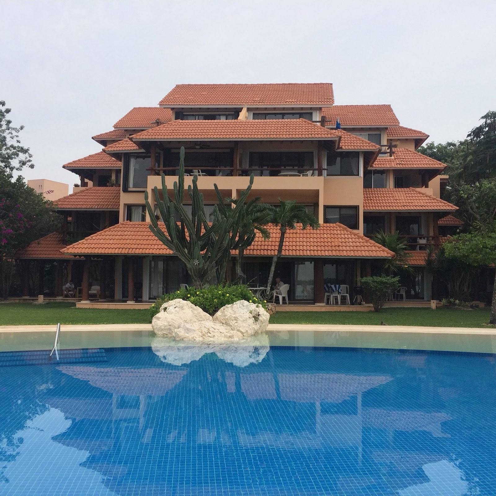 The building and its pool among the gardens