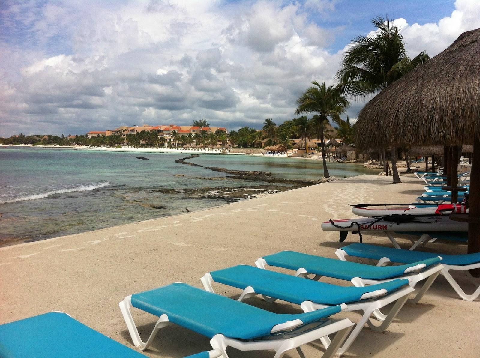 Loungers on the beach beside the palapa