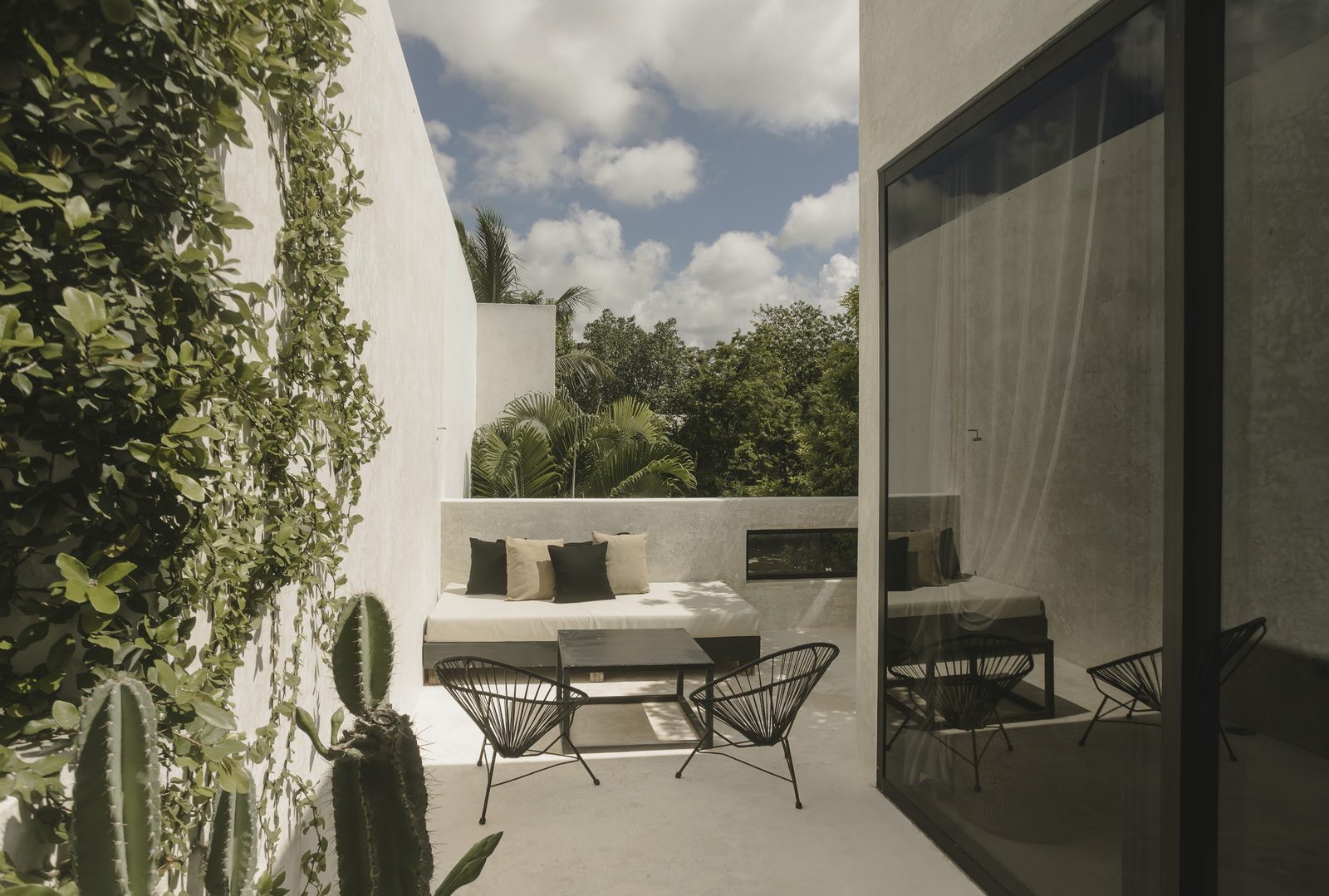 A shaded terrace with armchairs