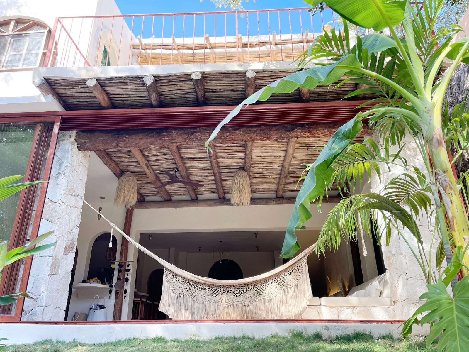 The house seen from the garden, with the palapa and the hammock