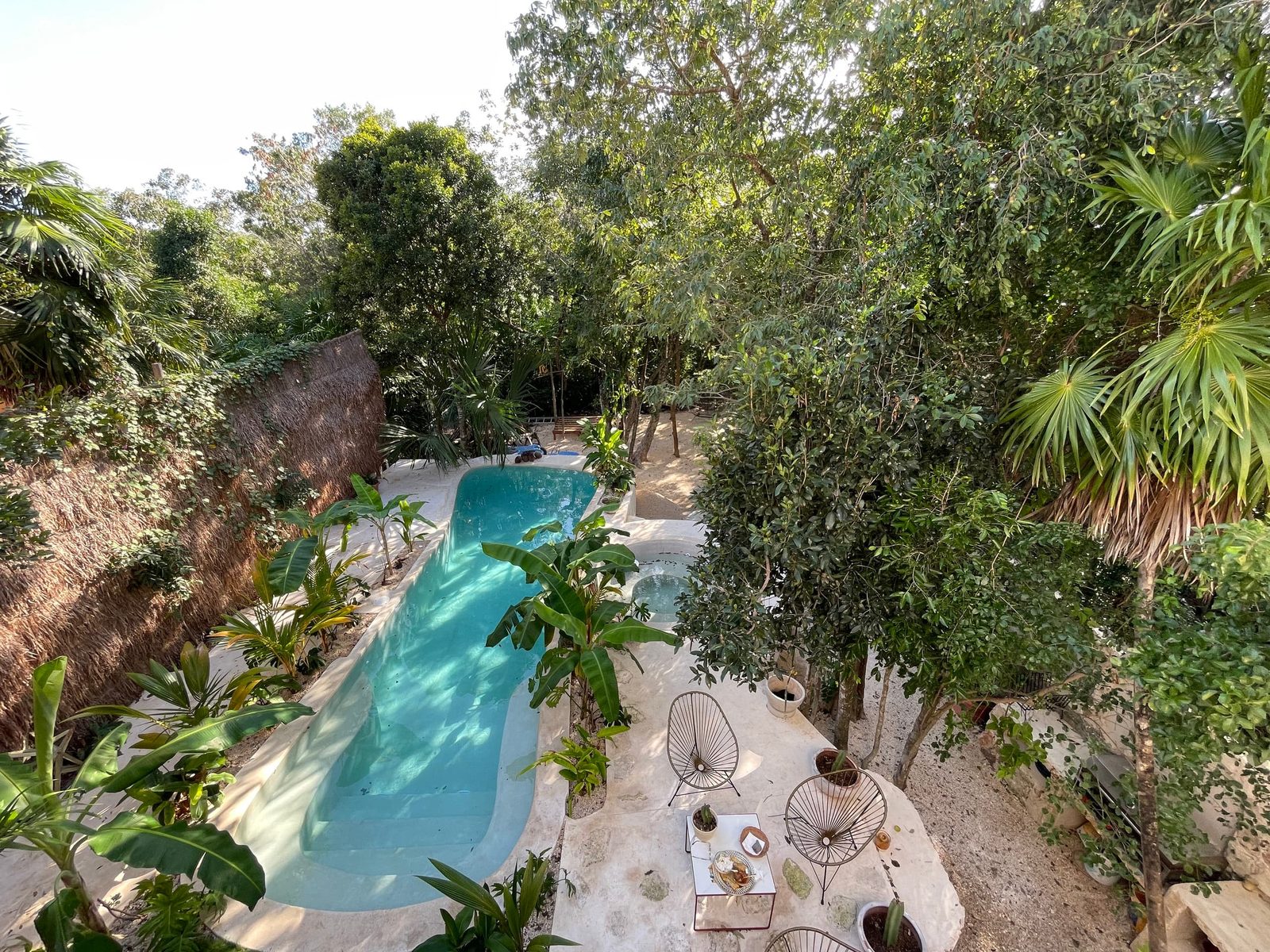 The long private pool running through the jungle garden