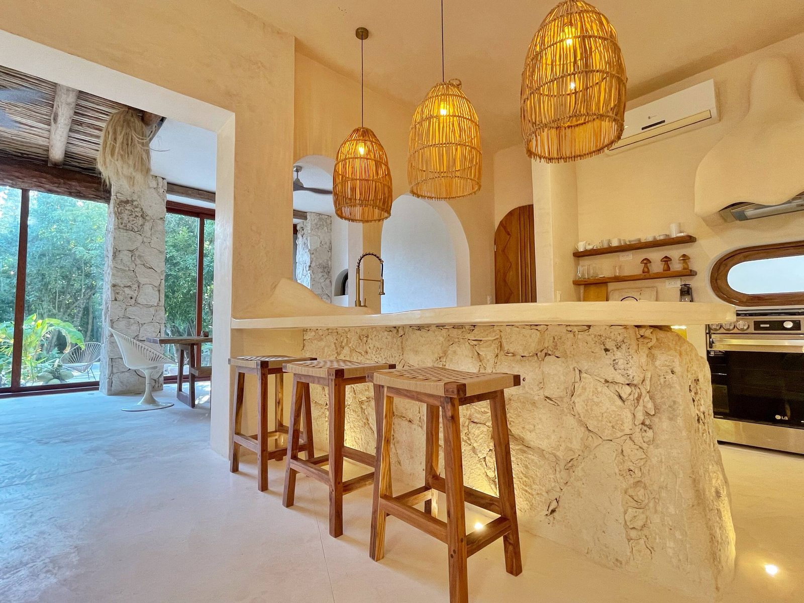 The kitchen with a stone bar and woven pendant lamps