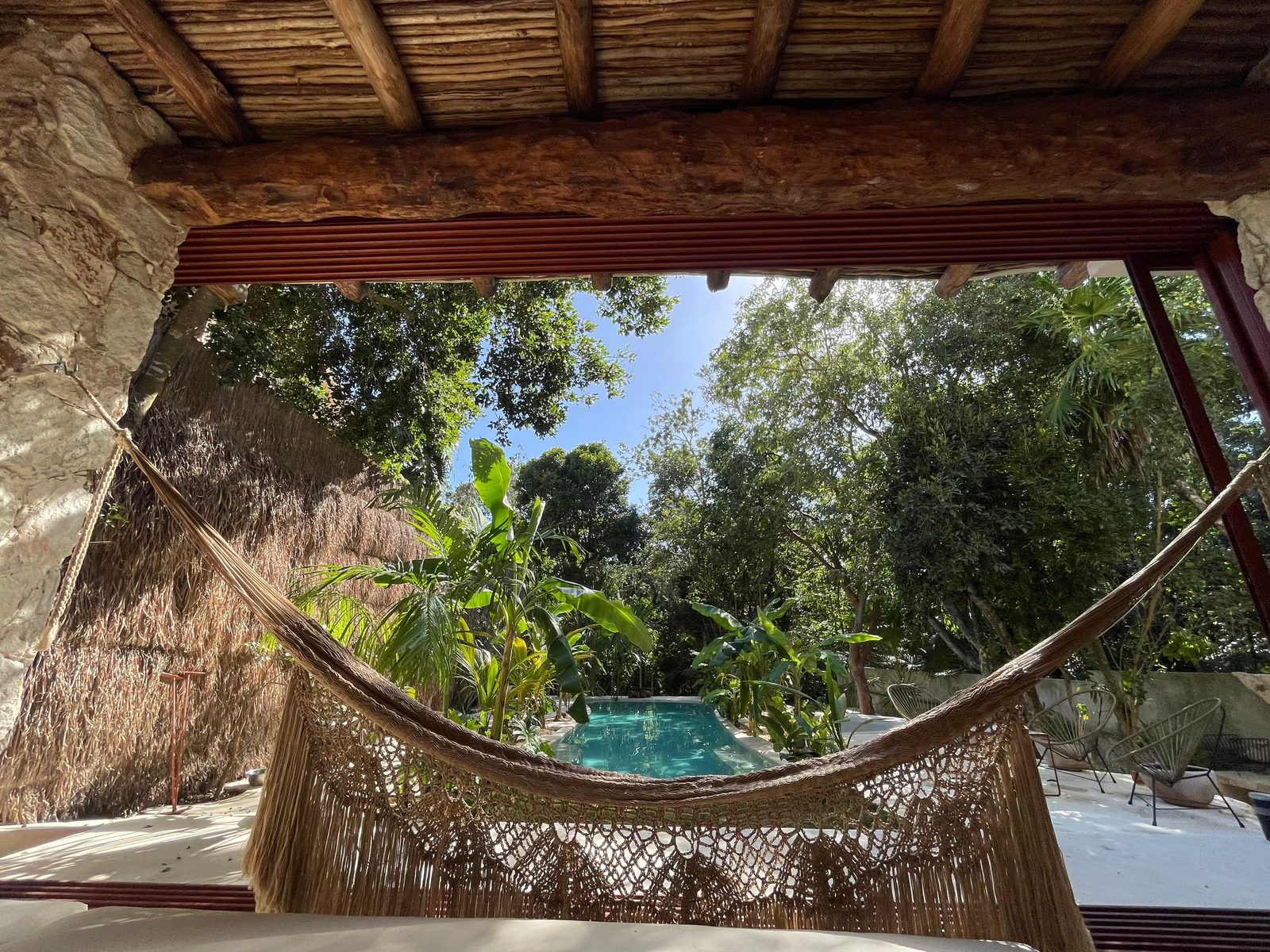 A hammock under the palapa, facing the pool