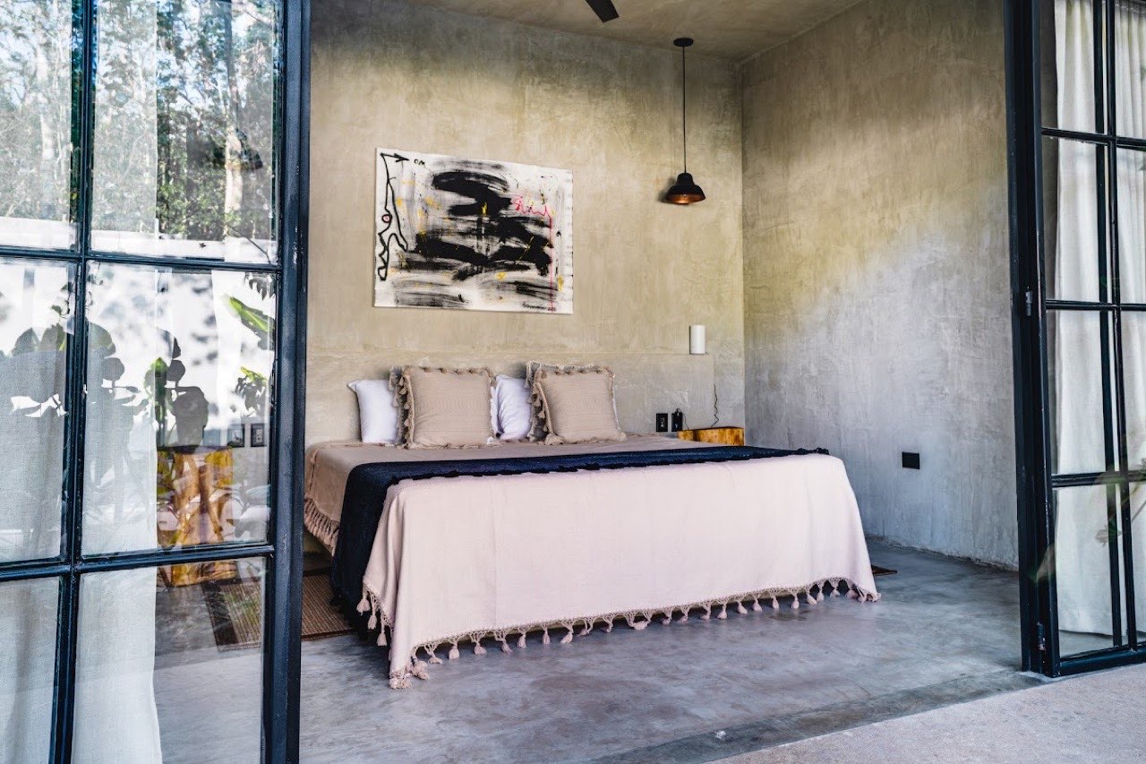 A bedroom with glass doors to the garden