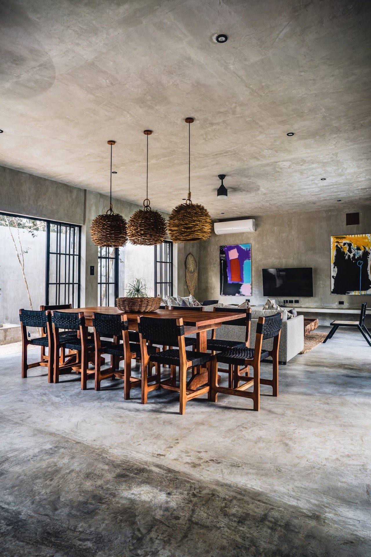 The dining table under woven pendant lamps
