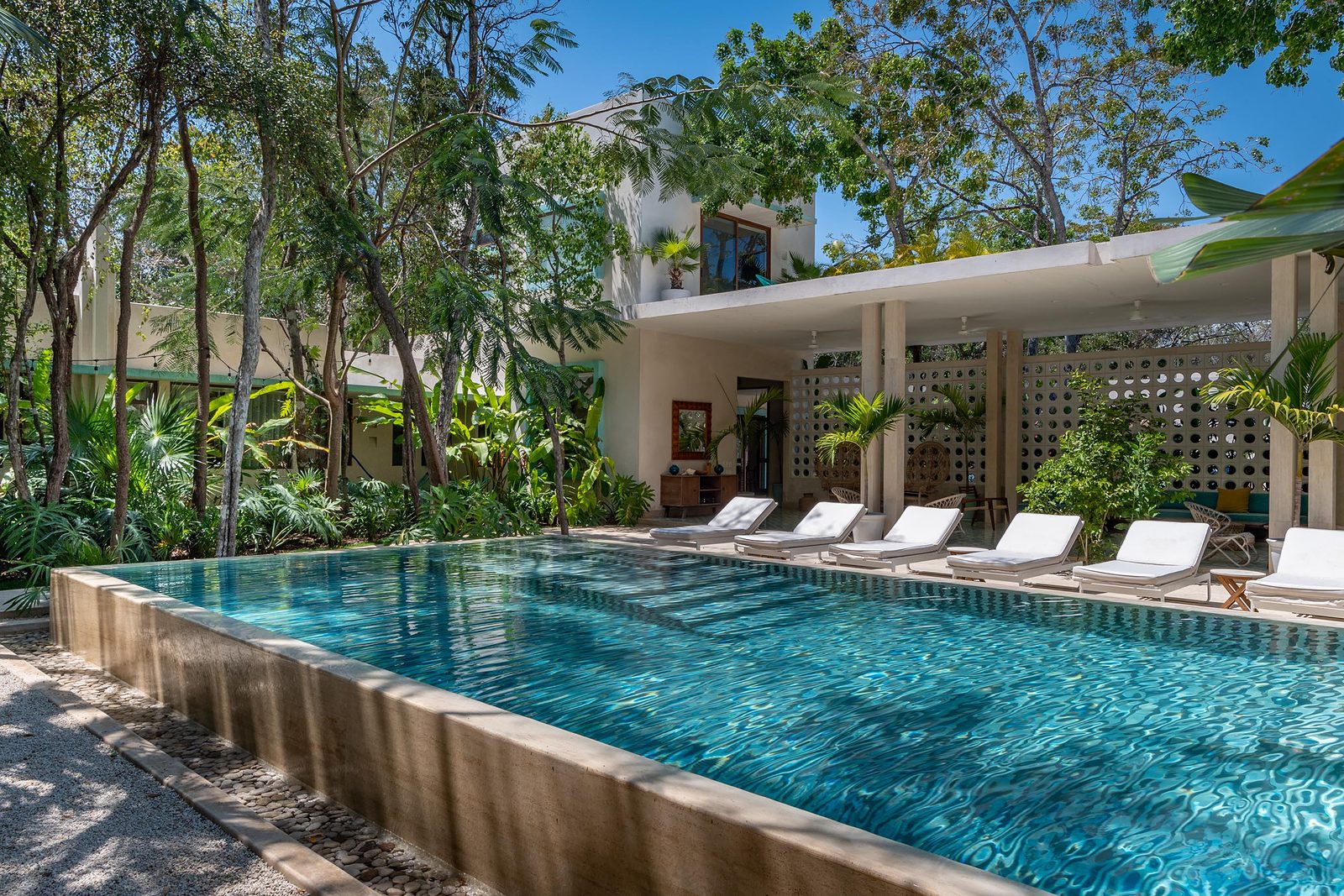 Mid-Century Villa in La Veleta, Tulum: the pool and the lounge pavilion among the trees
