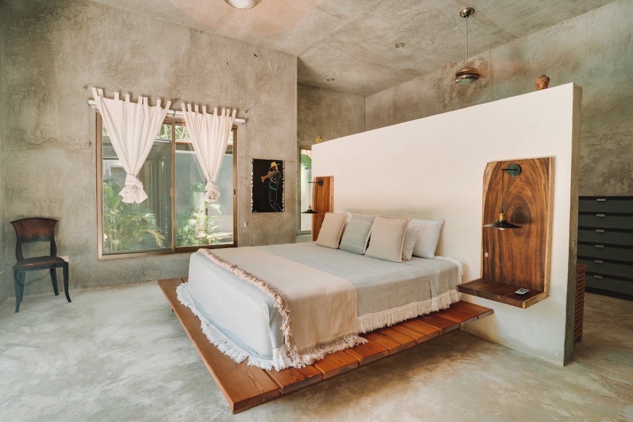 A bedroom with a floating wooden bed frame