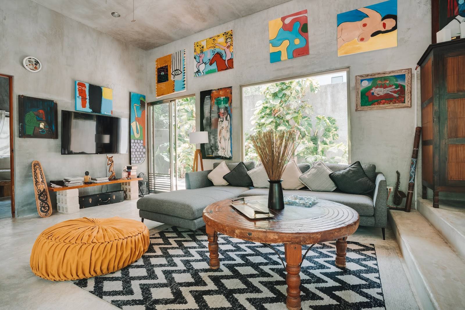 The living room with bright art and a round coffee table