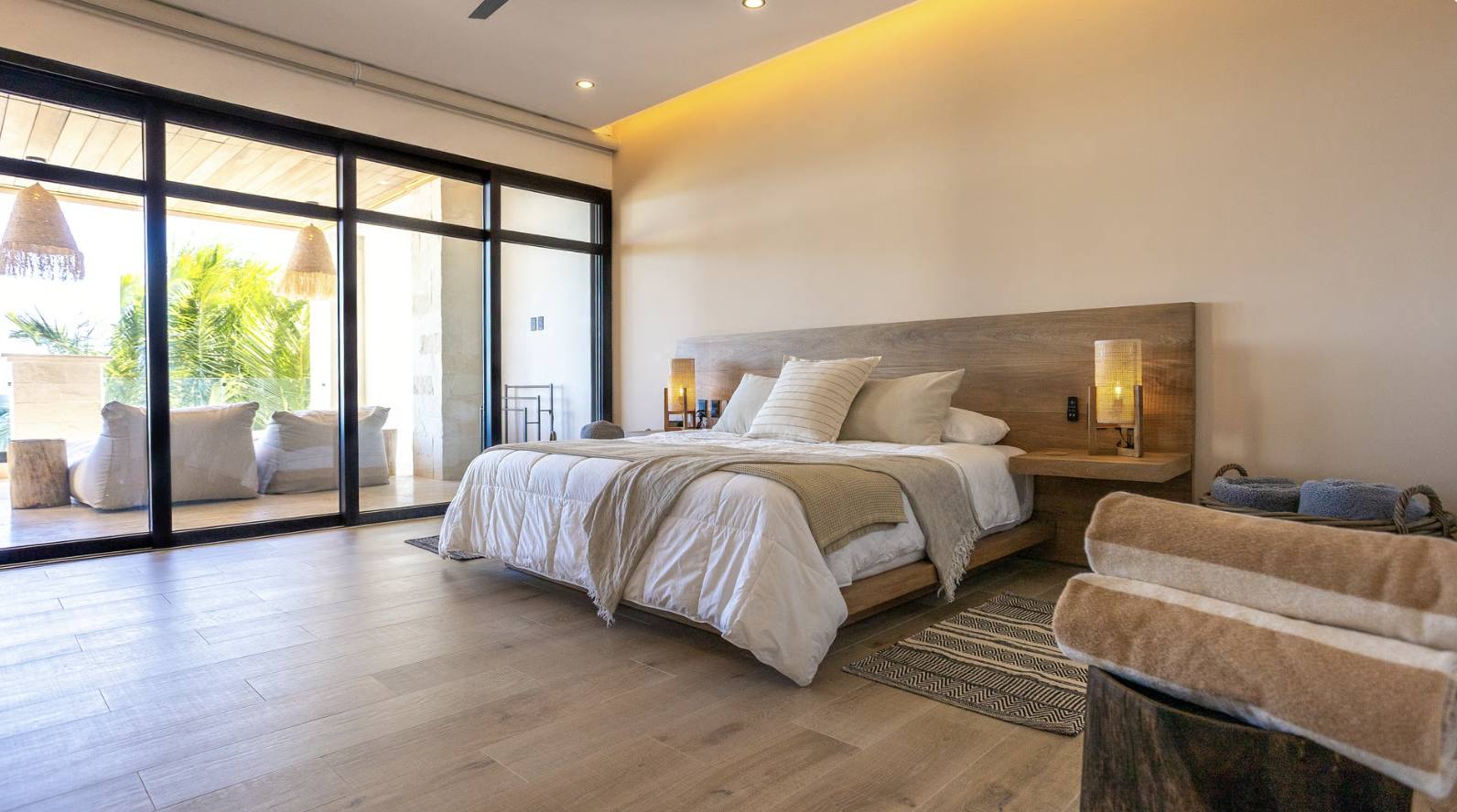 A bedroom opening onto a shaded terrace