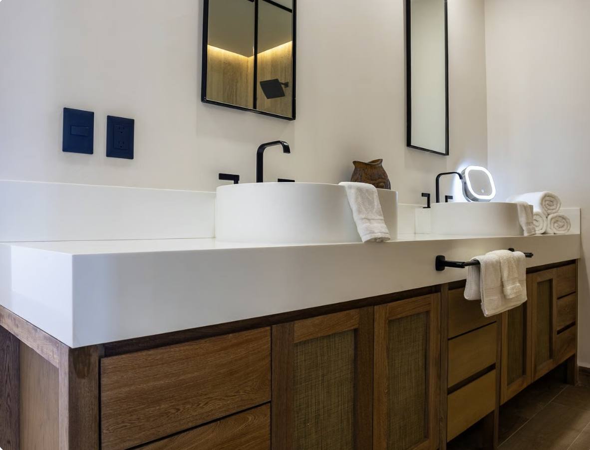 A double vanity with a wooden cabinet