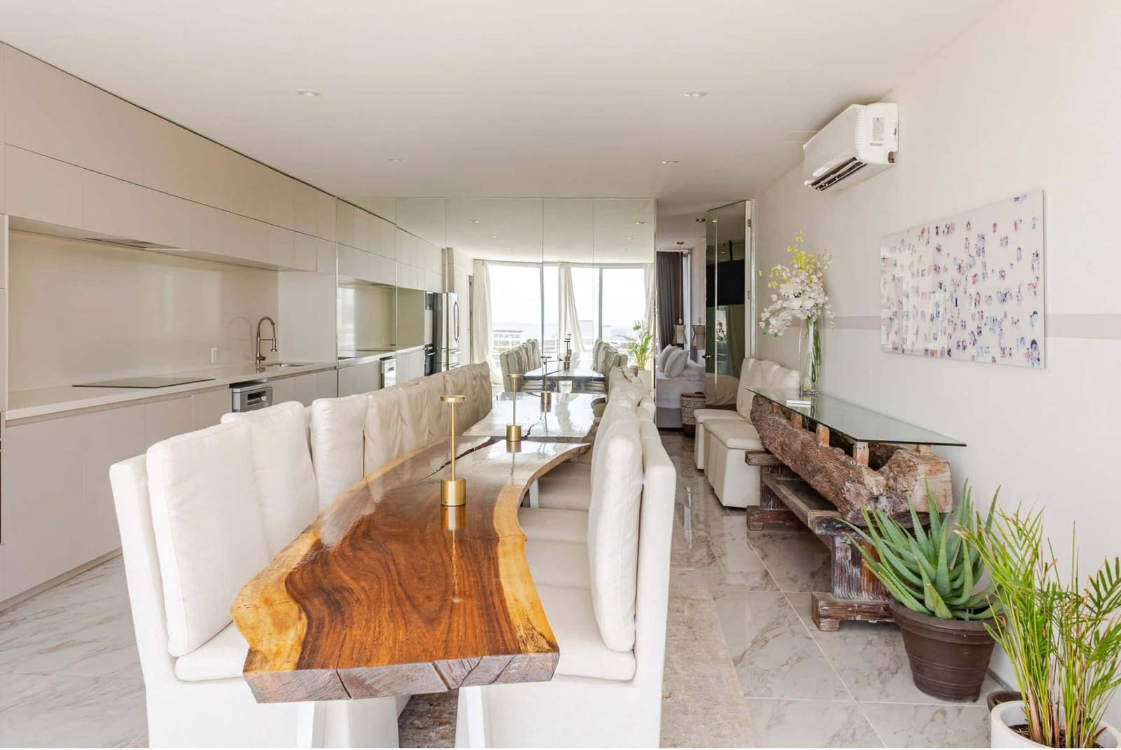 Long wooden dining table by the kitchen