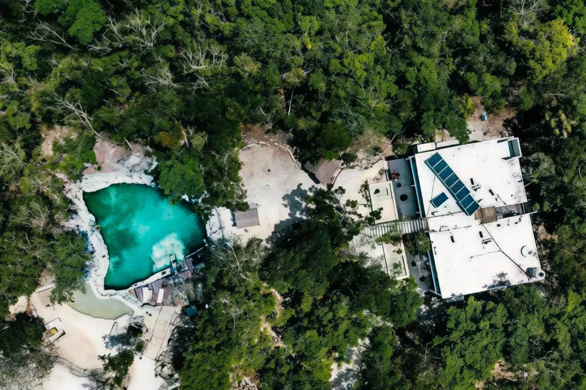 The villa and the cenote in the jungle, seen from the air