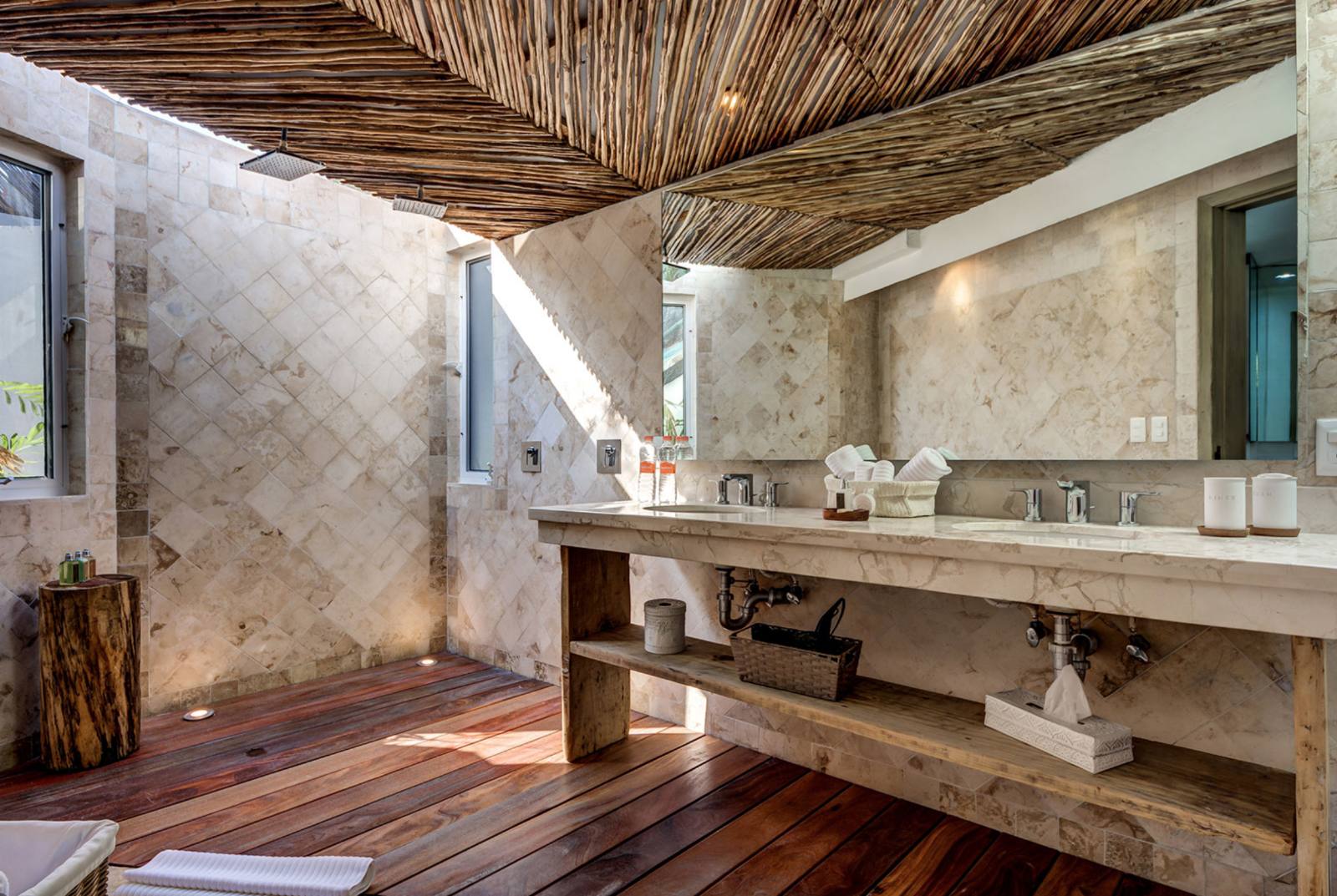 A bathroom with a stone vanity and a cane ceiling