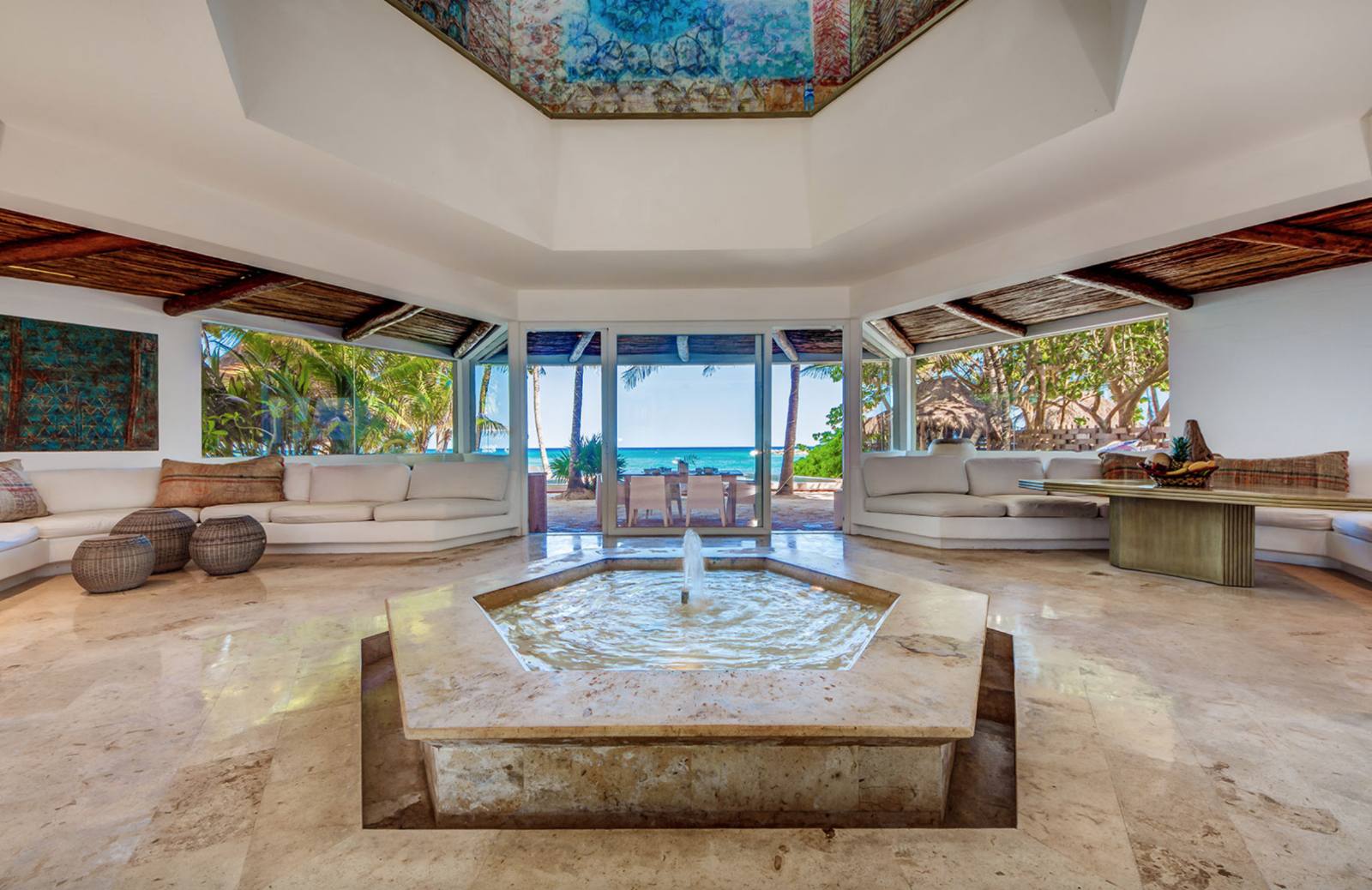 The living room around an indoor fountain, open to the sea