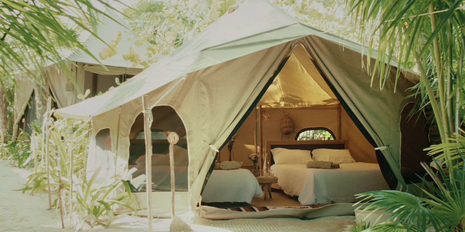 The bell tent among palms and plants