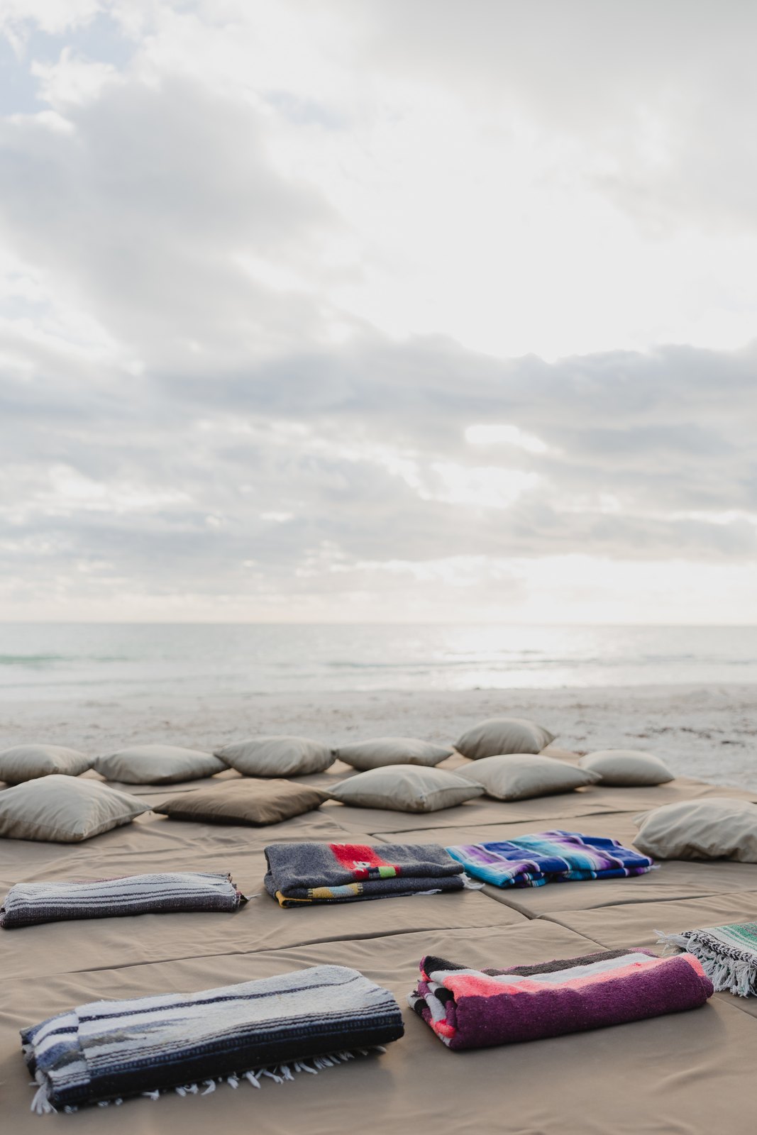 Cushions laid out on the beach at sunrise