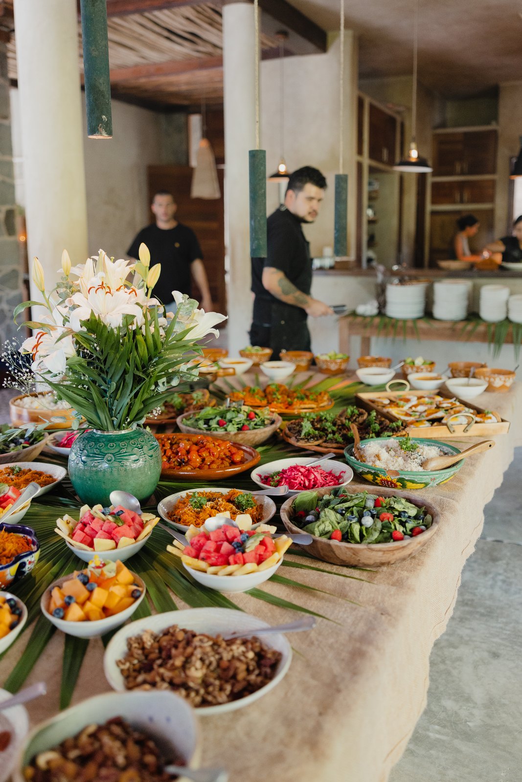 A colorful table of salads, fruit and local dishes