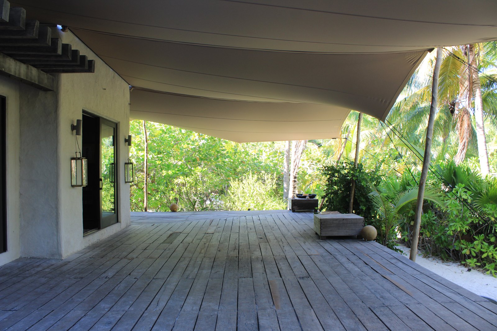 The covered wooden deck of the villa, open to the jungle