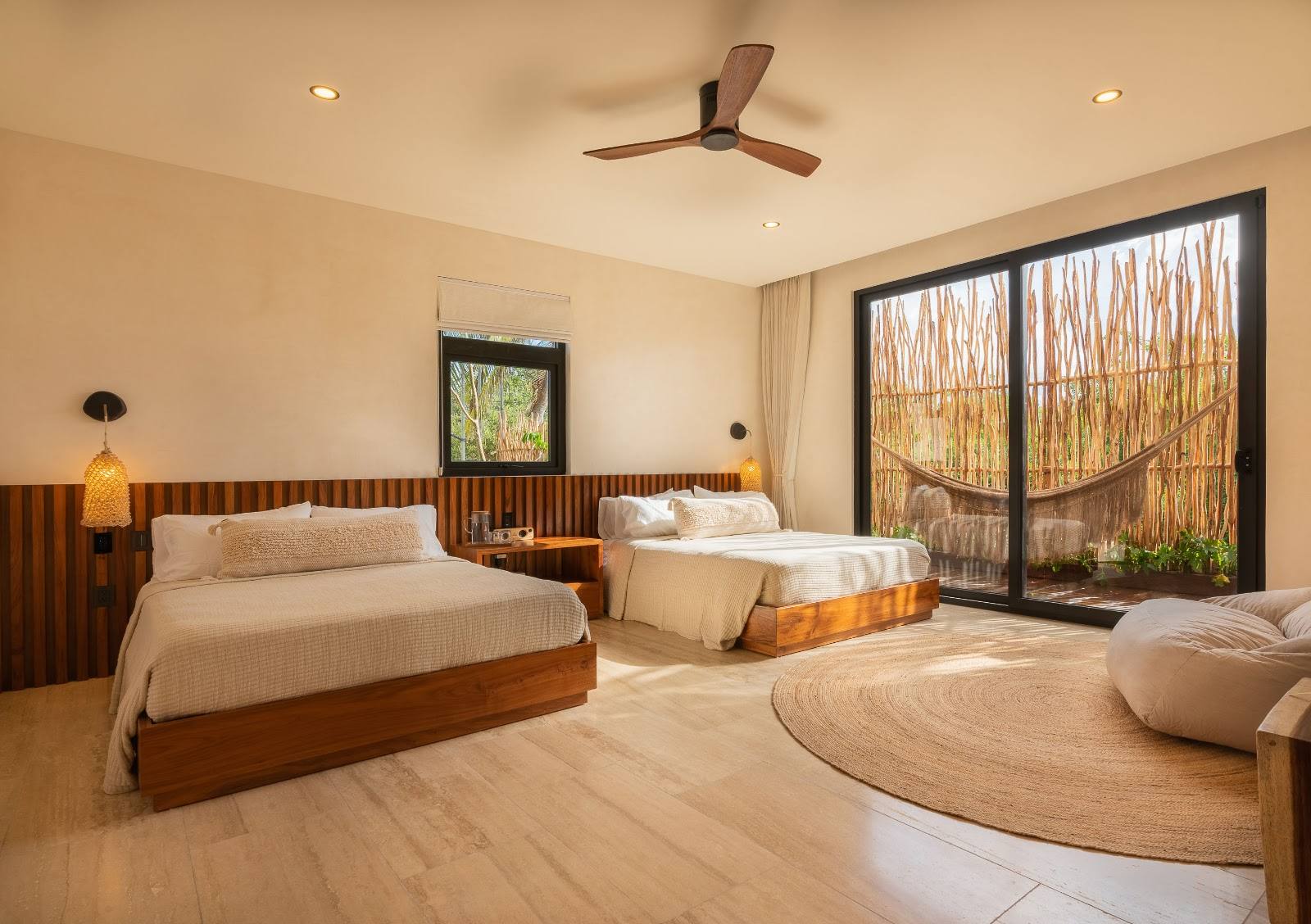 A room with two beds and a jungle-view terrace